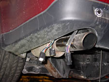 run the cable along the opening underneath the car directly behind the bumper